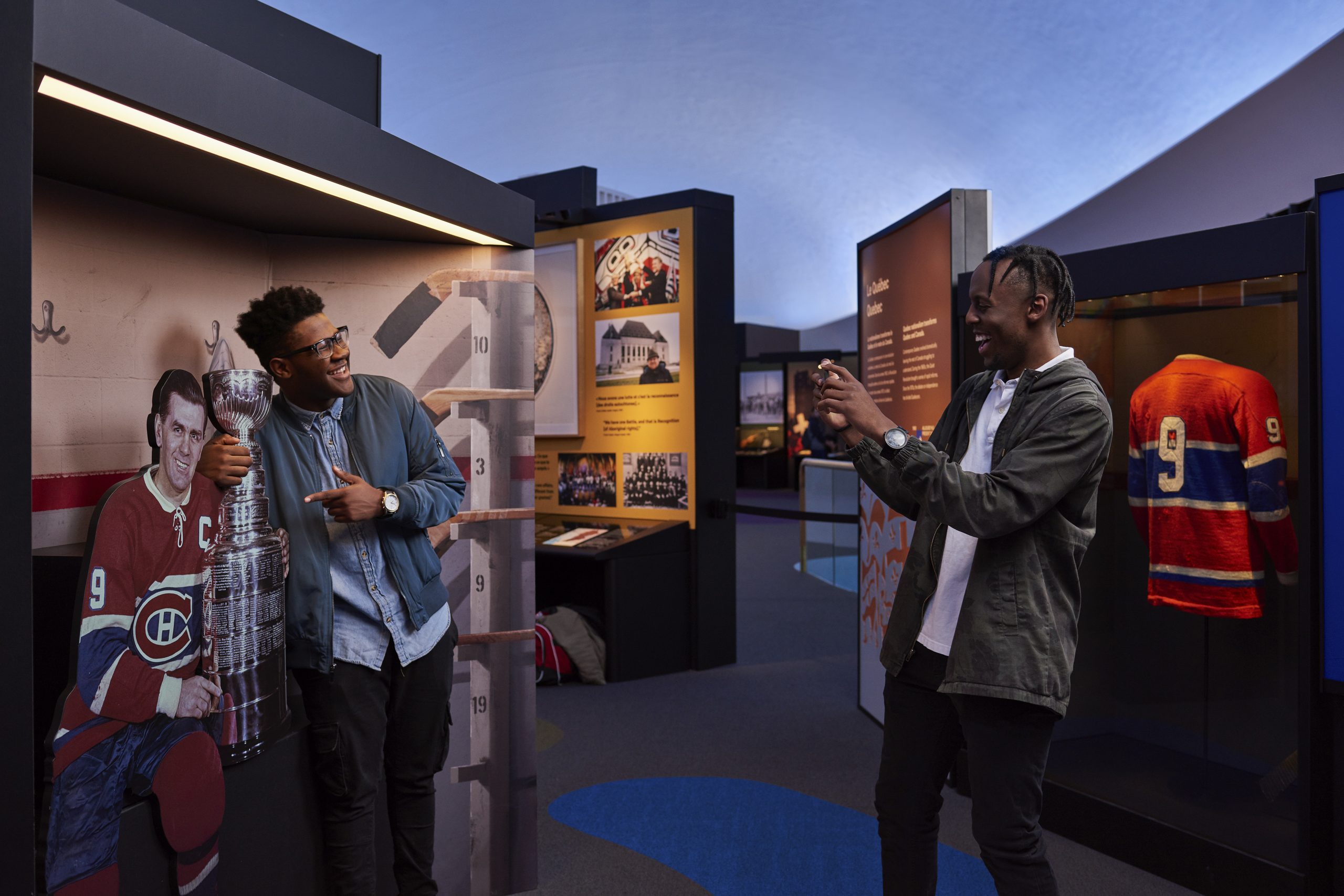 Two men looking at a display of hockey memorabilia in the Canadian Museum of History.