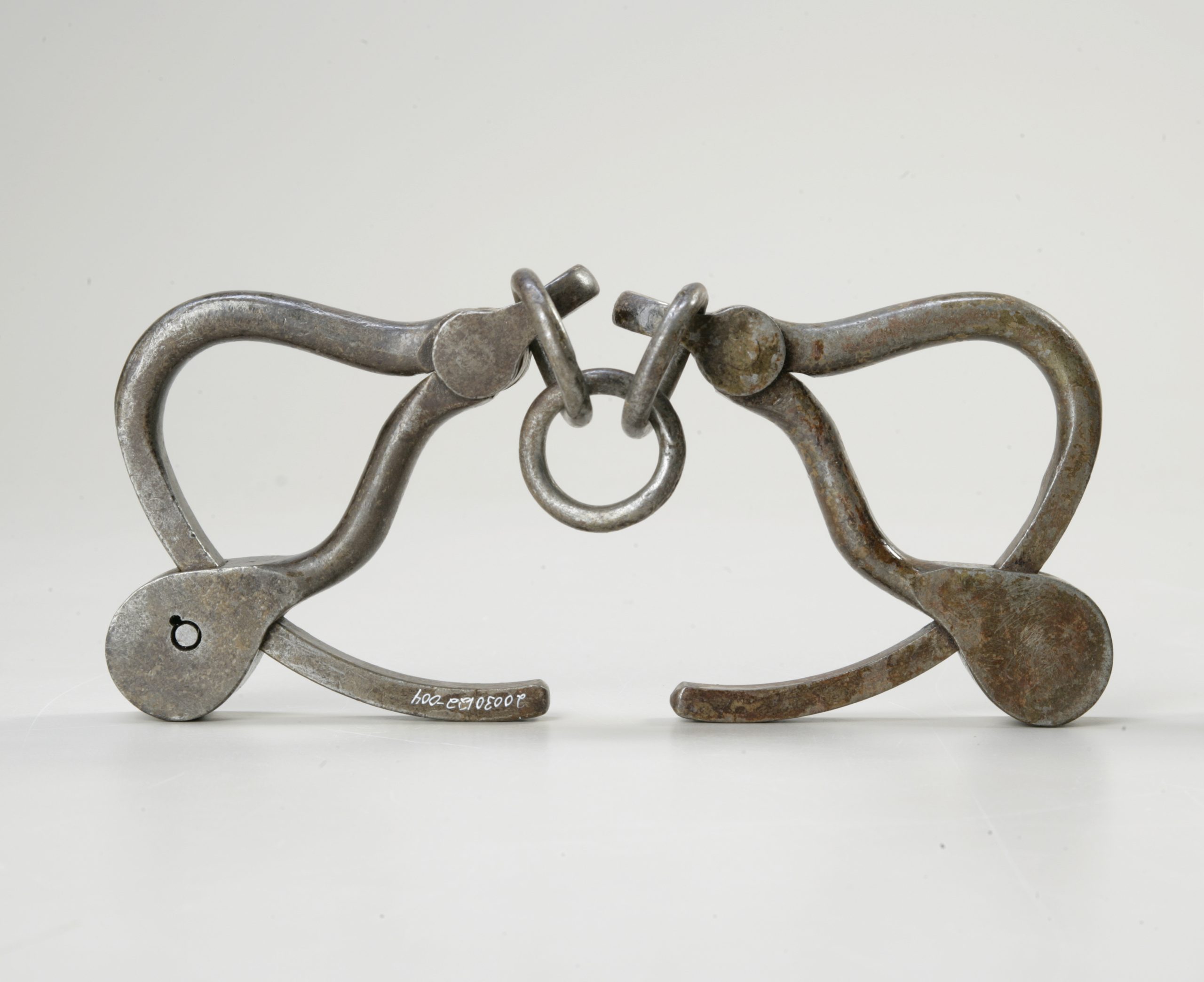 A pair of metal clamps on a white background at the Canadian Museum of History in Ottawa.