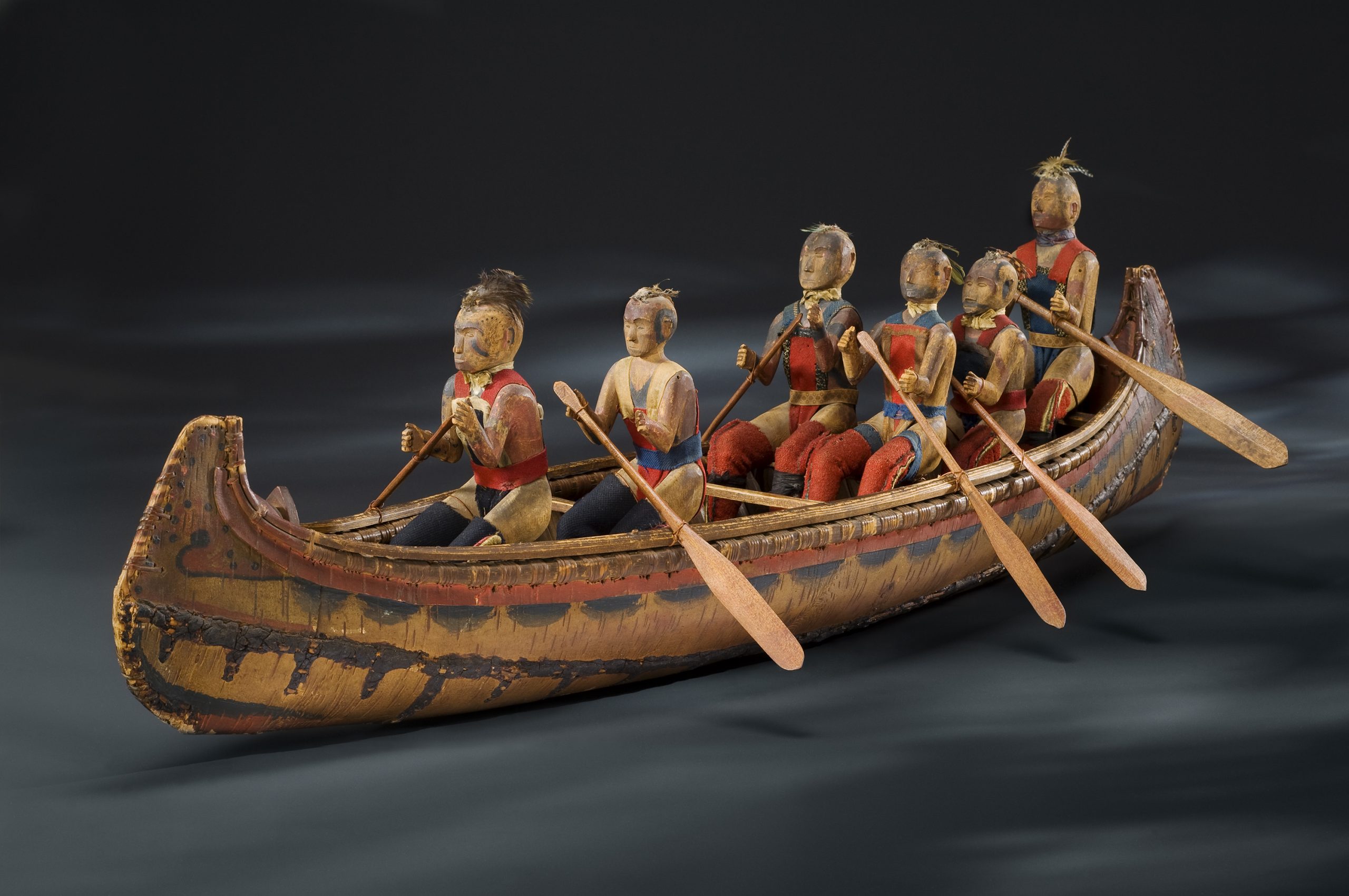 A model of a canoe with a group of people in it, on display at the Canadian Museum of History in Ottawa.