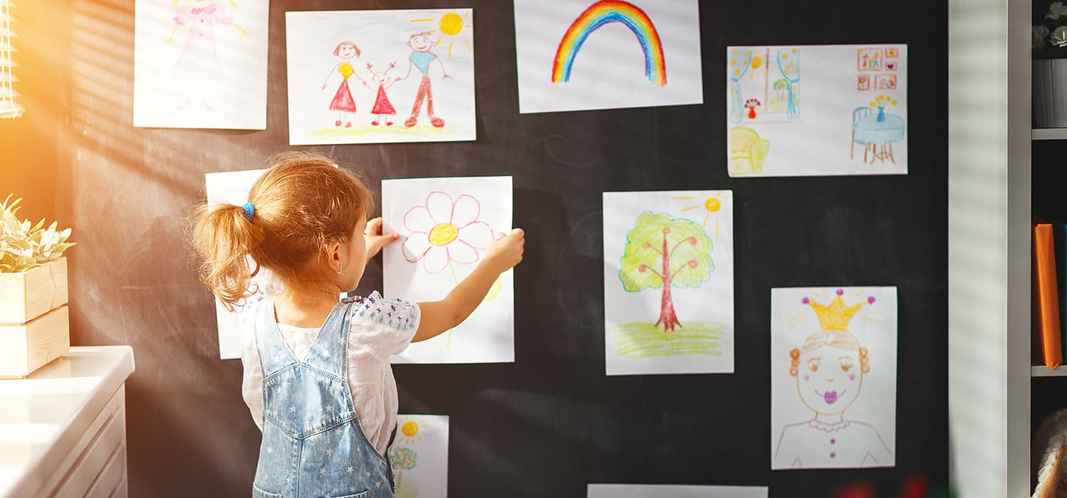 A little girl is drawing on a blackboard at the Canadian Museum of History in Ottawa.