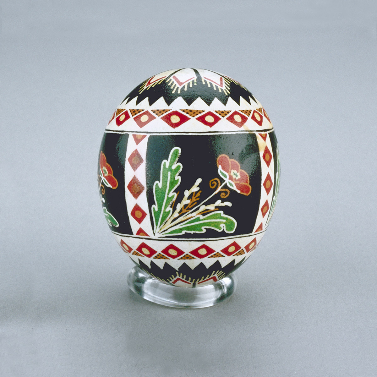 A black and red painted egg on a stand displayed in the Canadian Museum of History in Ottawa.