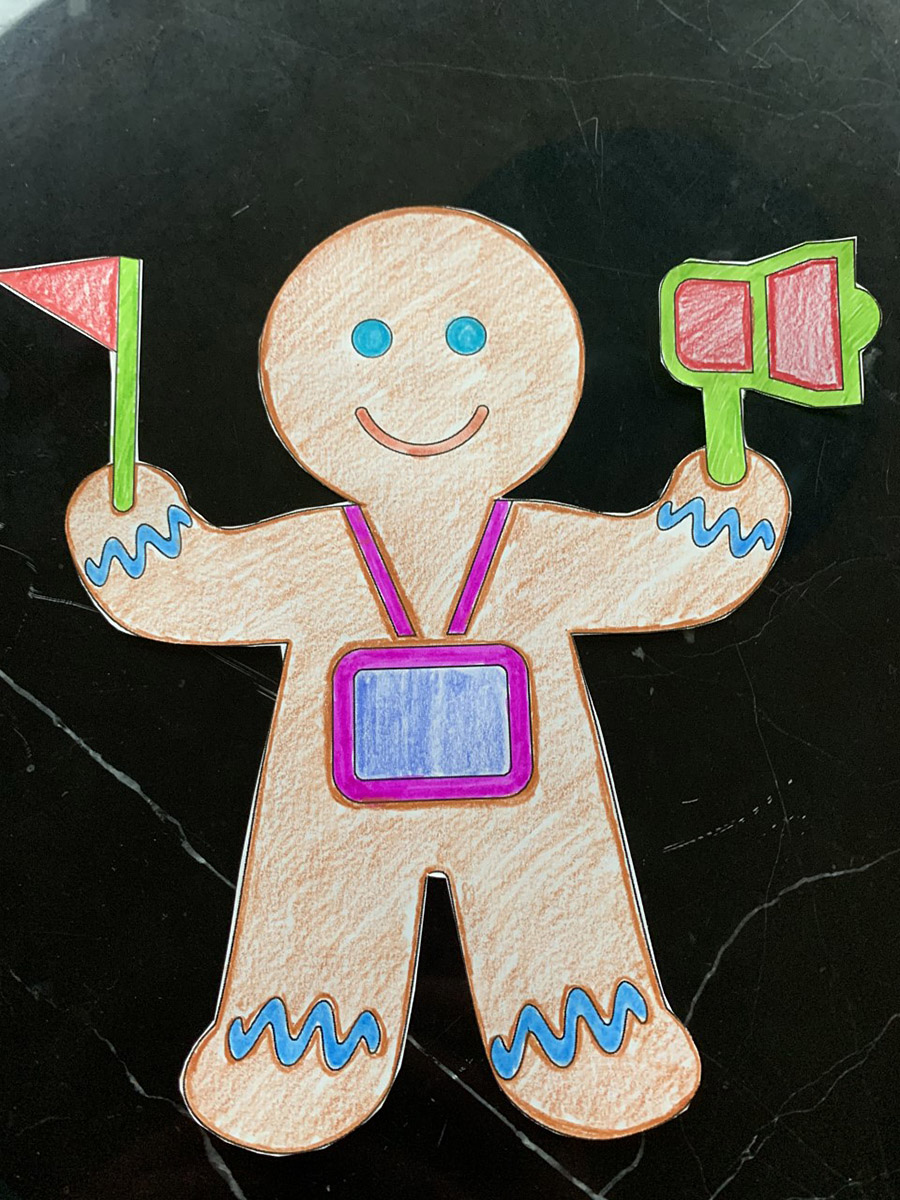 A paper, coloured gingerbread man holding a flag in Ottawa.