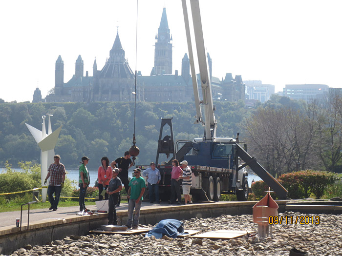 A group of people standing next to a crane at the Canadian Museum of History in Ottawa.