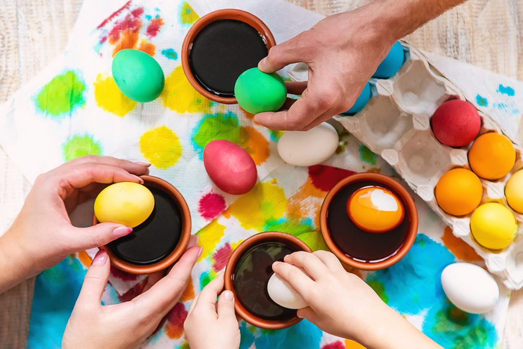 A group of people painting Easter eggs in Ottawa at the Canadian Museum of History.