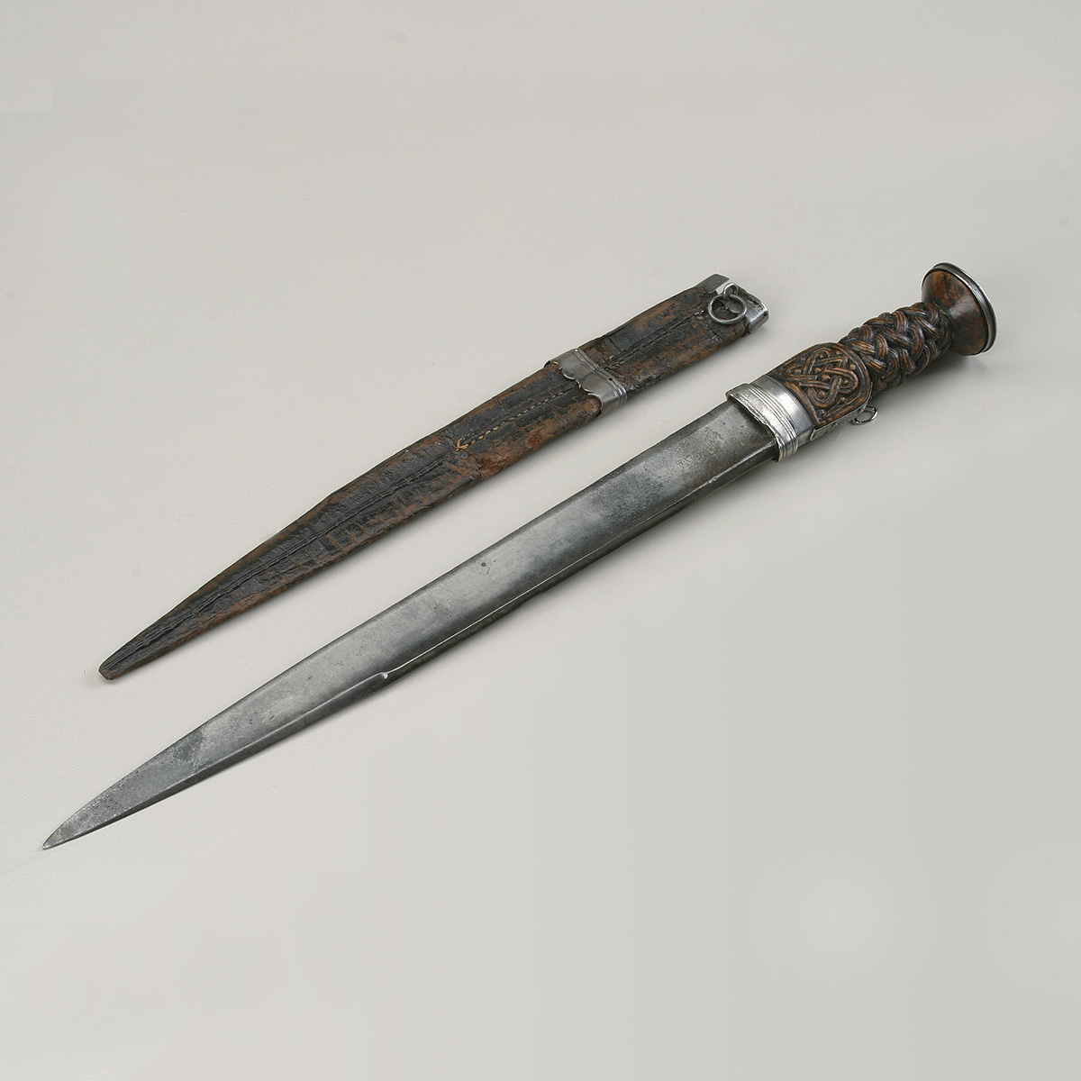 A sword and a knife on a white surface at the Canadian Museum of History.