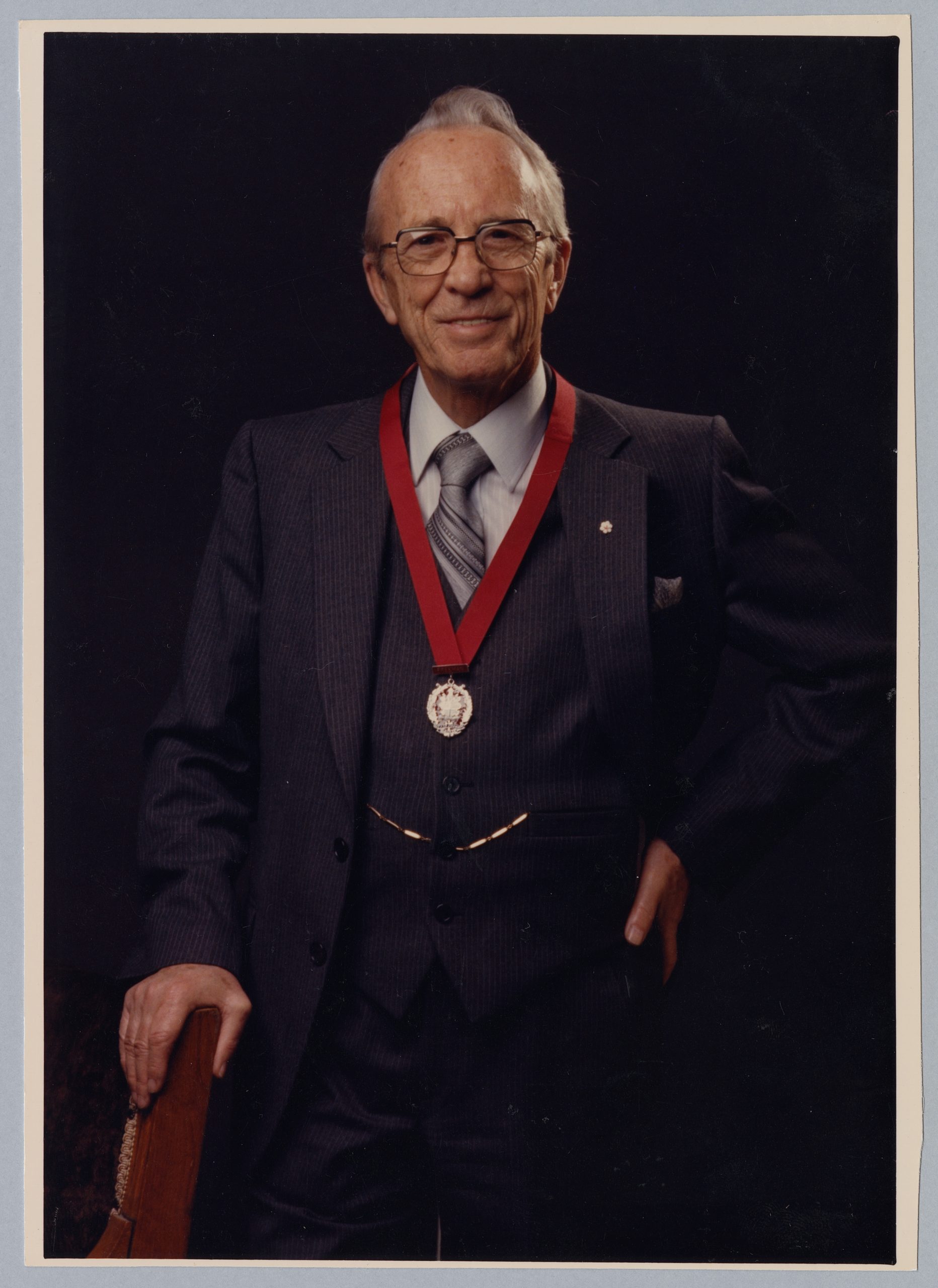 A man in a suit and tie wearing a medal at the Canadian Museum of History in Ottawa.