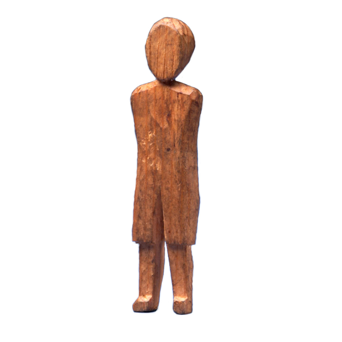 A wooden figure standing on a white background in the Canadian Museum of History.