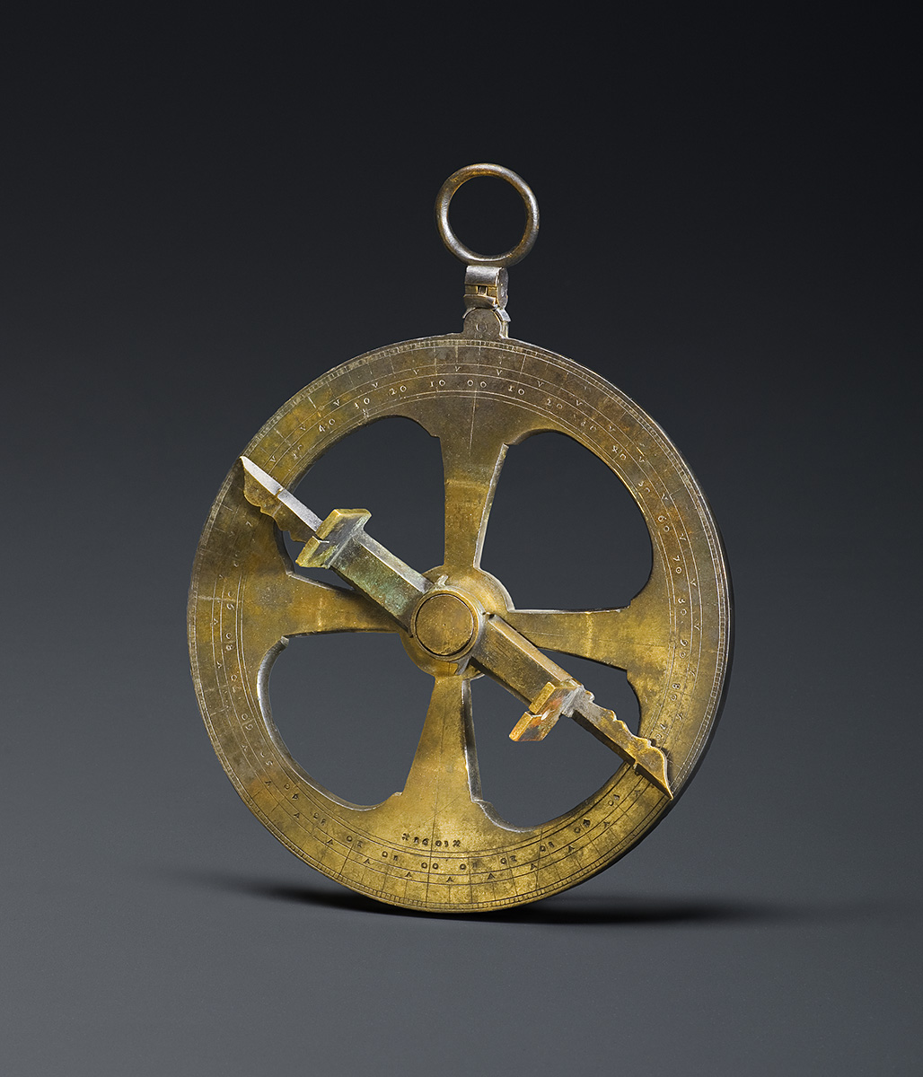 A brass compass on a black background displayed at the Canadian Museum of History in Ottawa.