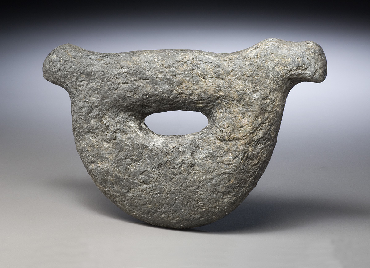 A stone object with a hole in it, on display at the Canadian Museum of History in Ottawa.