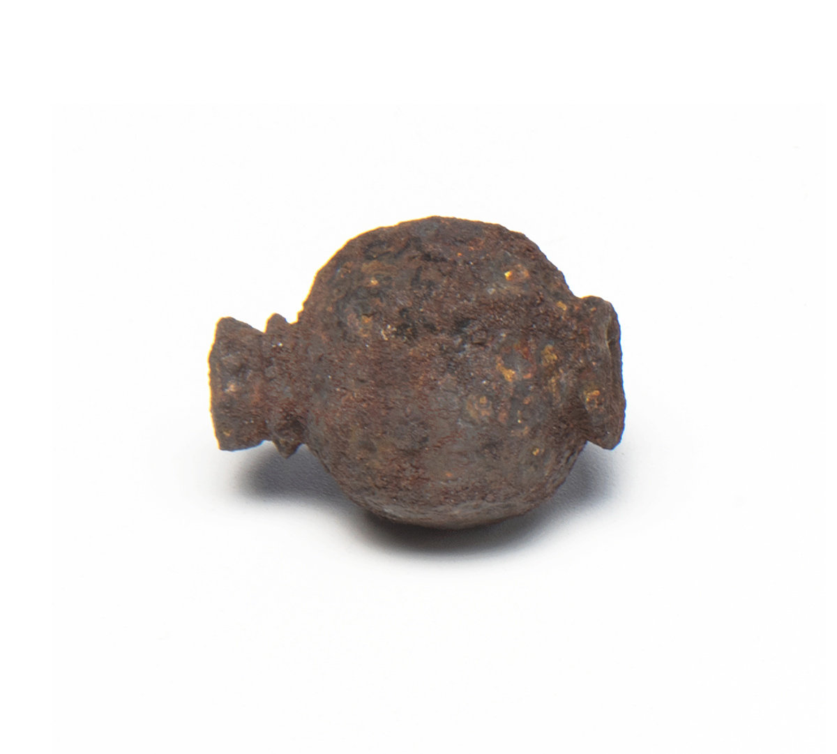 A rusted iron ball on a white surface at the Canadian Museum of History in Ottawa.