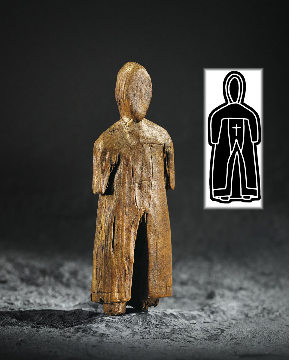 A wooden figure with a hood and cloak displayed at the Canadian Museum of History in Ottawa.