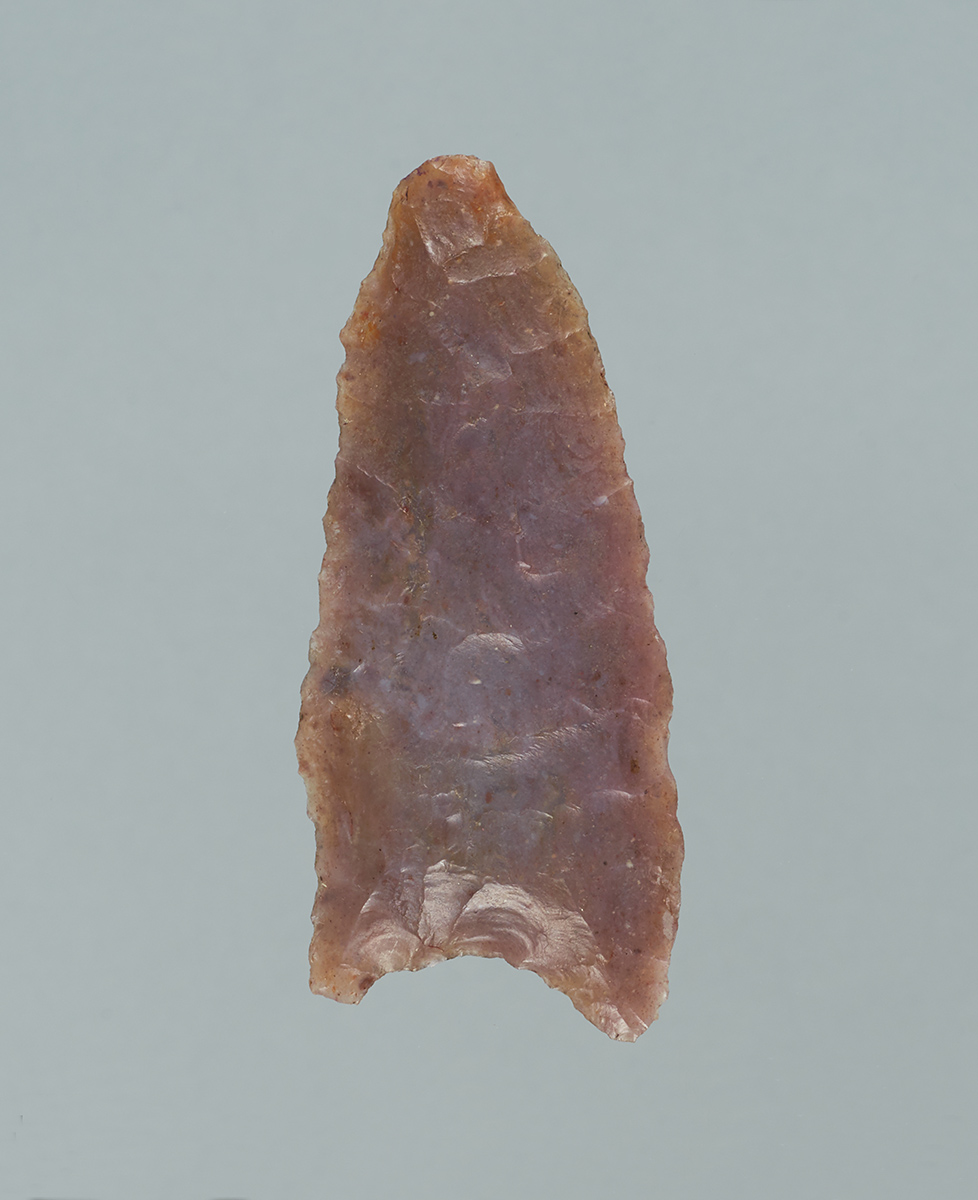 An Indian arrowhead on a gray background displayed at the Canadian Museum of History in Ottawa.