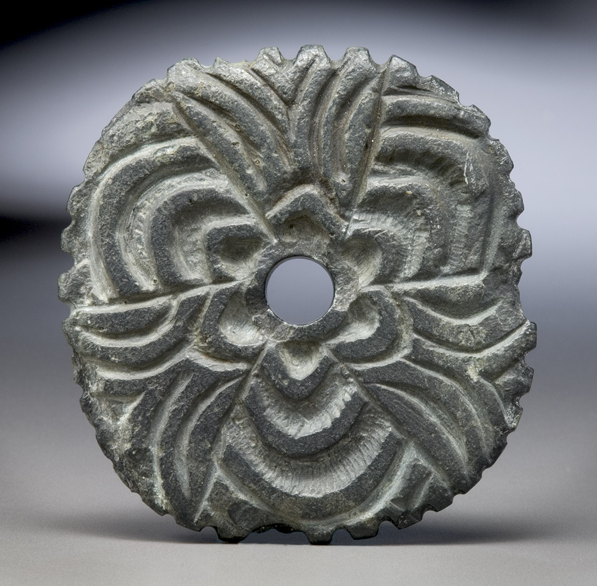 A bronze disc with a flower on it, exhibited at the Canadian Museum of History in Ottawa.