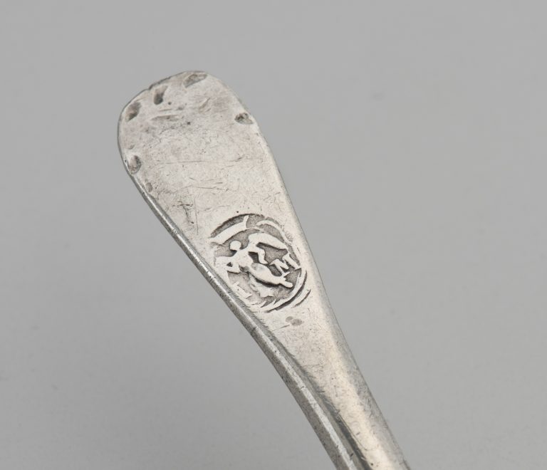 The angel touch mark on the handle of a pewter spoon.