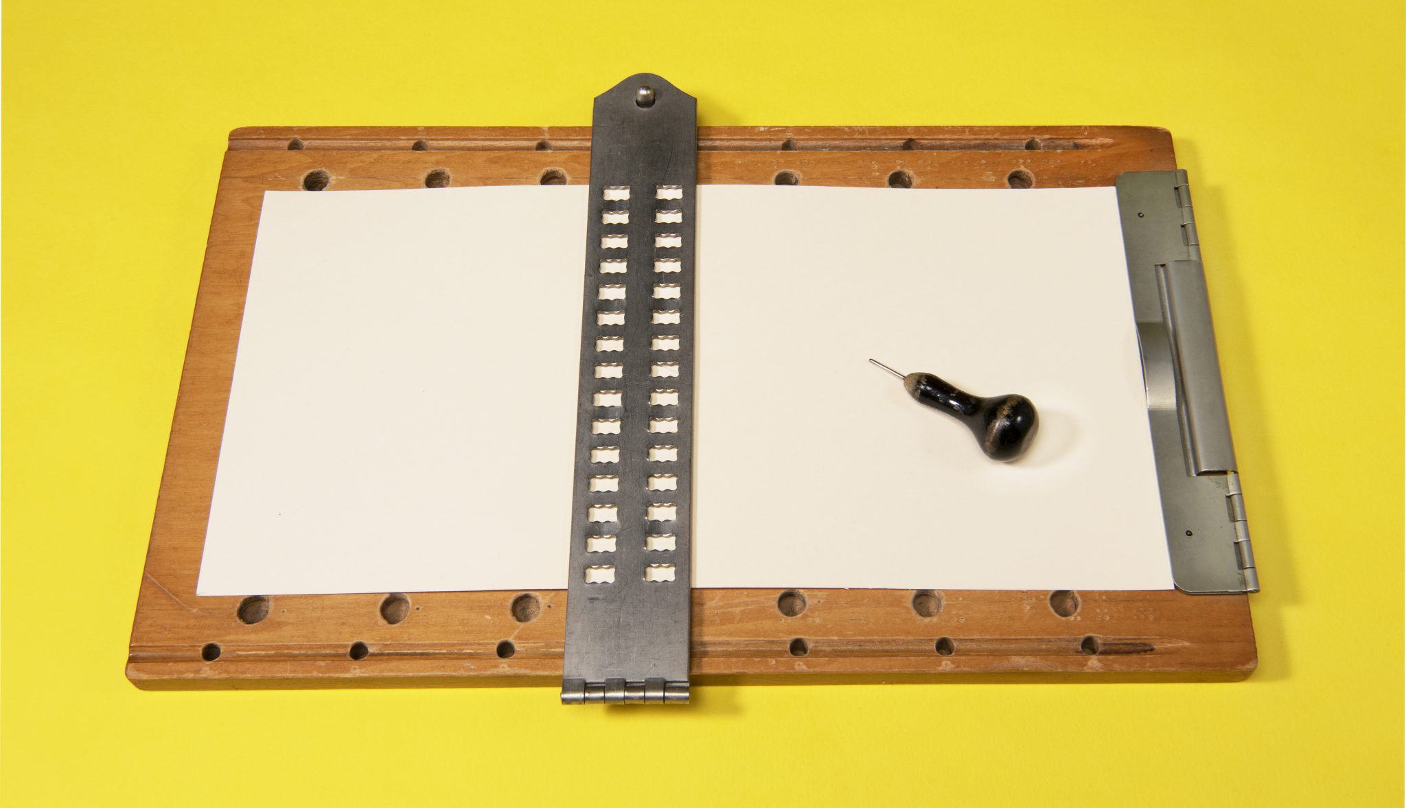 A braille tablet and stylus.