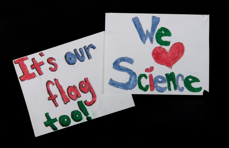 Two signs displaying our love for science amidst the Freedom Convoy and pandemic protests in Ottawa.