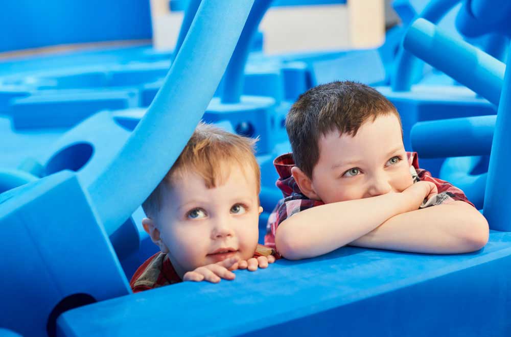 Children with big blue foam blocks