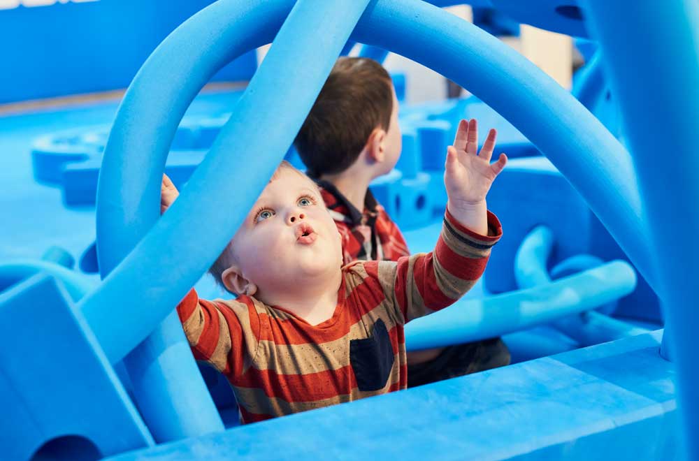 Children with big blue foam blocks