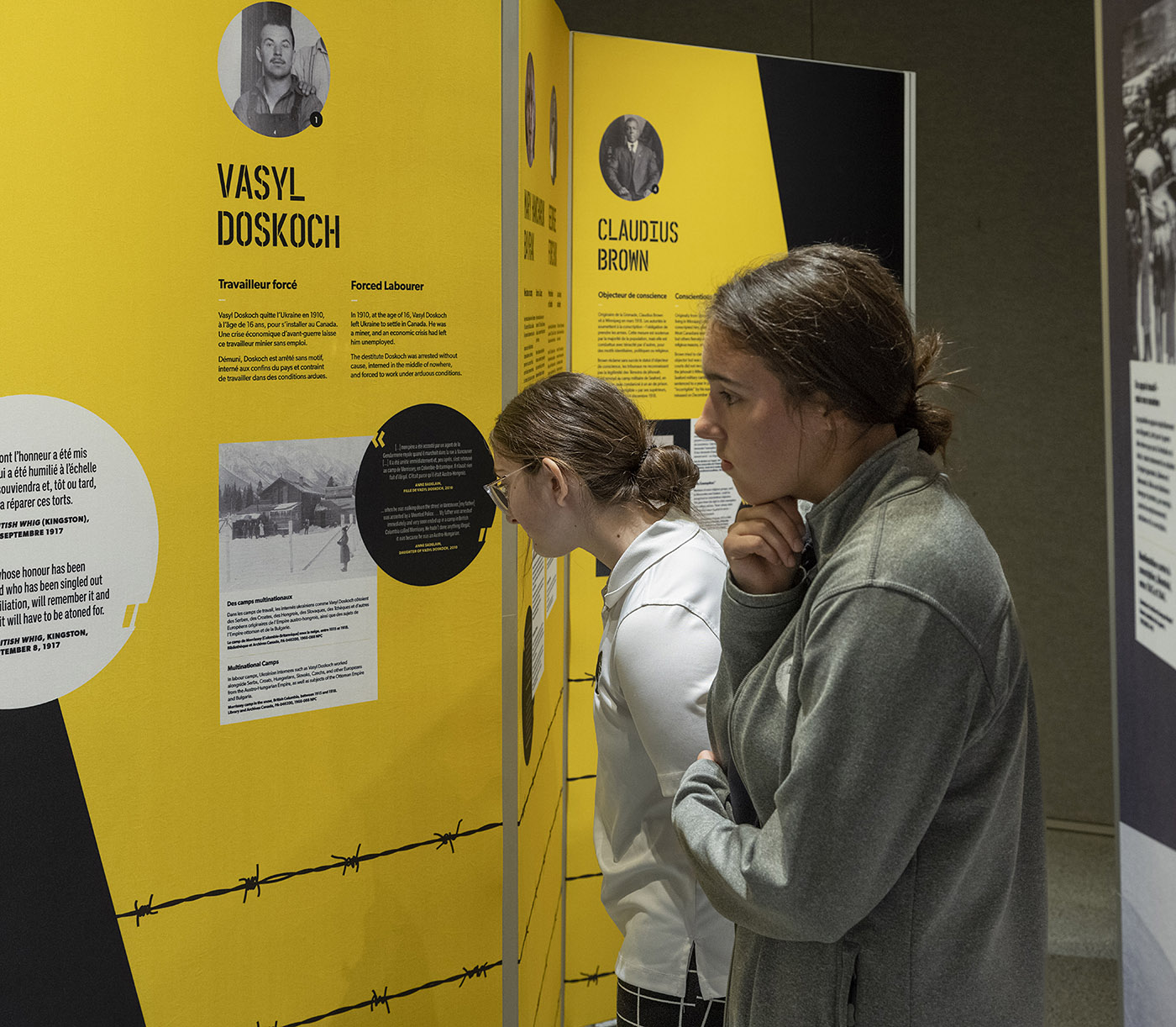 Two young people look intently at a display of text and images